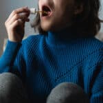 Young Woman Using Cannabis Tinctures Sublingually