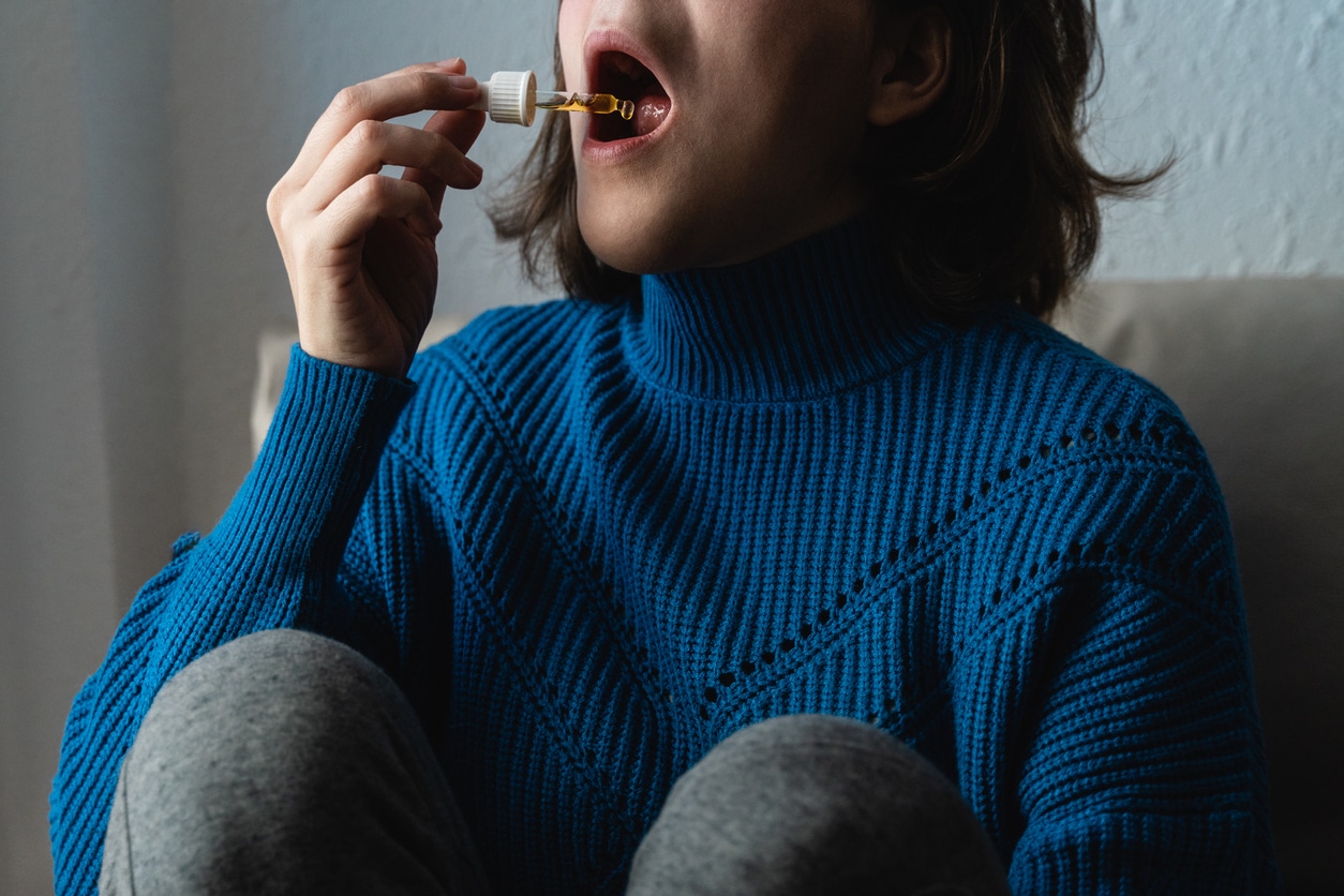 Young Woman Using Cannabis Tinctures Sublingually